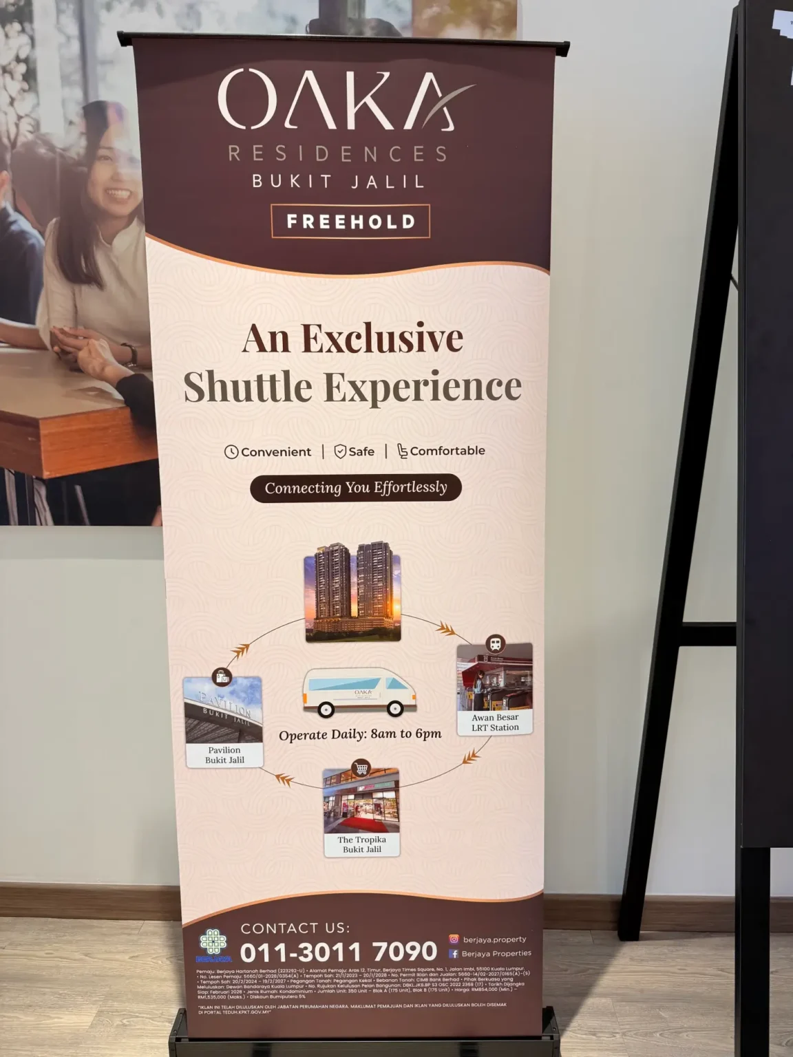 OAKA developer-branded shuttle display listing Pavilion Bukit Jalil, Awan Besar LRT and The Tropika, with daily hours of 8am to 6pm